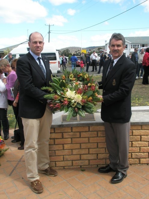 Commodore Matt Allen (left) and Commodore Clive Simpson with the wreath they laid at the Seafarers Memorial Wall at Triabunna last Saturday.  Photo:  Lisa Allen  © SW